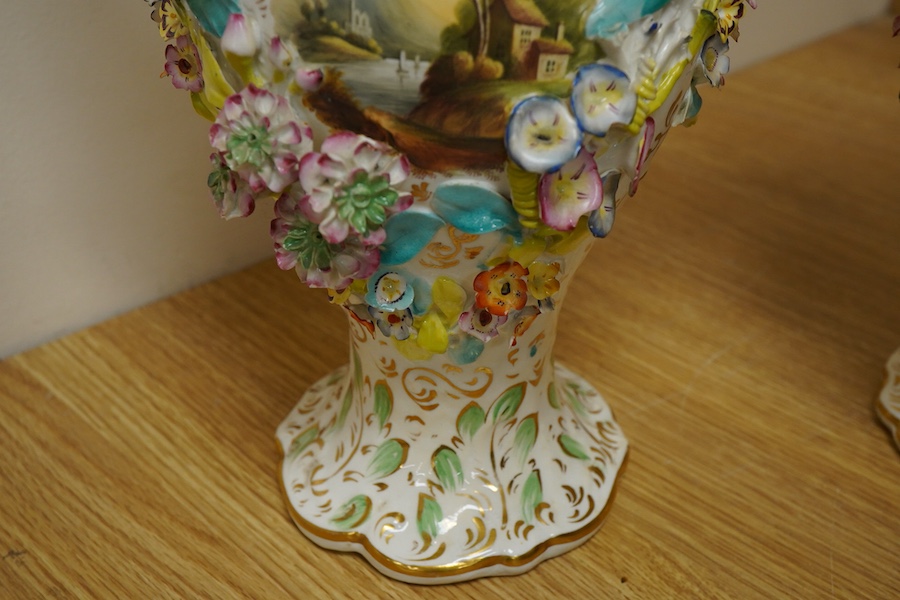 A pair of English porcelain floral encrusted vases and covers, c.1830, possibly Samuel Alcock, each painted with landscapes, 44cm high